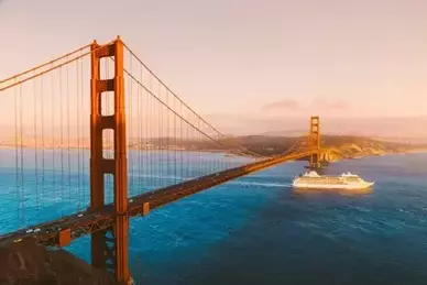 Golden Gate Bridge with the cruise ship at sunset, San Francisco, California, USA