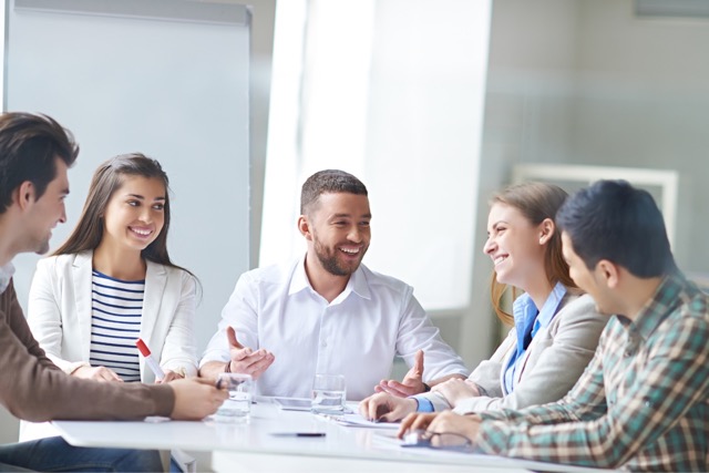 Smiling businessman with colleagues in meeting